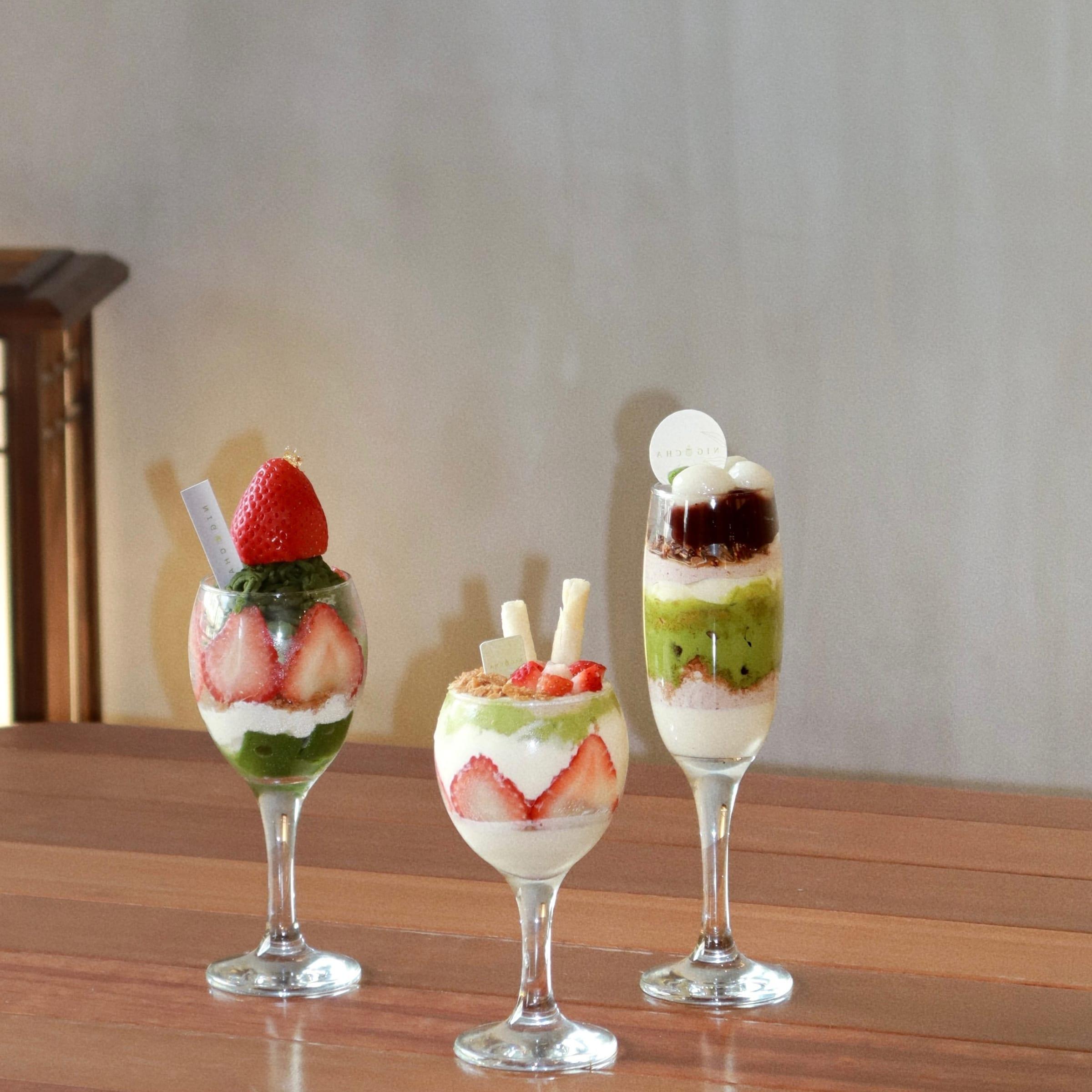 Three matcha parfaits in tall glasses