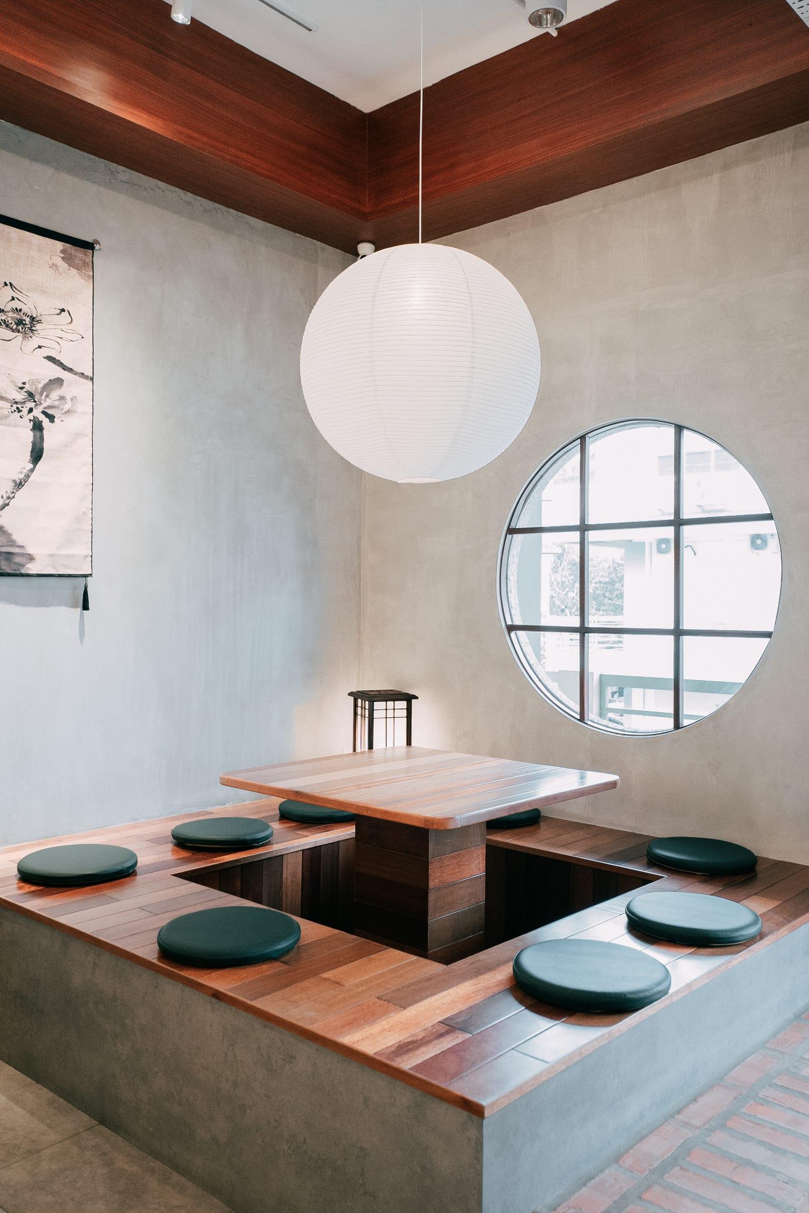 Inside Nigocha Matcha: a paper lantern, the round window and the sunken tables